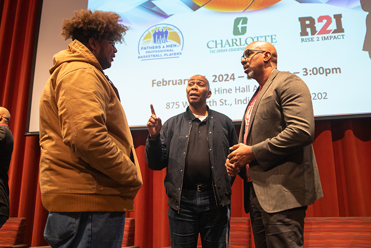 Dr. Hayes and Tim Williams discussing with a student