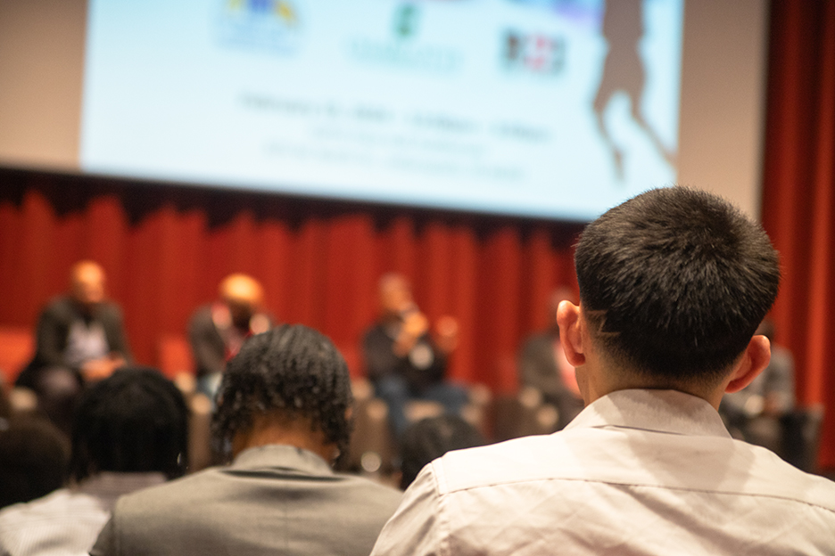 Student in the audience watching the panel